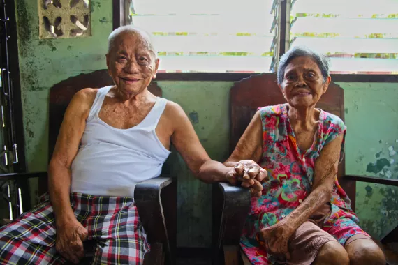 Elderly leprosy patients couple in Philippines holding hands