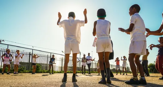A group of children playing outside and learning about heart health in South Africa