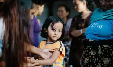 A young child is inspected for leprosy as part of the Leprosy Post-Exposure Prophylaxis Program (LPEP) in Nepal