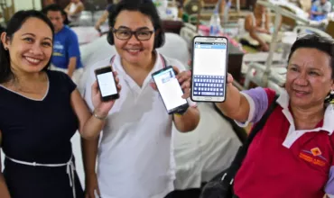 Image of three women presenting LEARNS App on their mobile phones