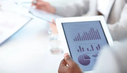 Close up picture of a white tablet displaying metrics