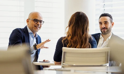 Three business people discussing in a meeting room