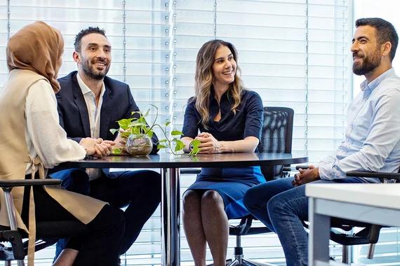 Four business people discussing in a meeting room