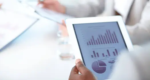 Close up picture of a white tablet displaying metrics