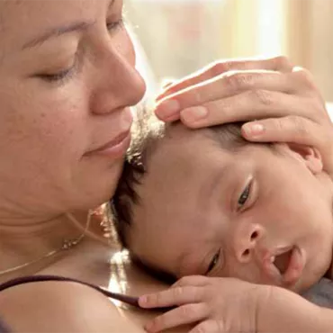 Mother with a Baby lying on her chest